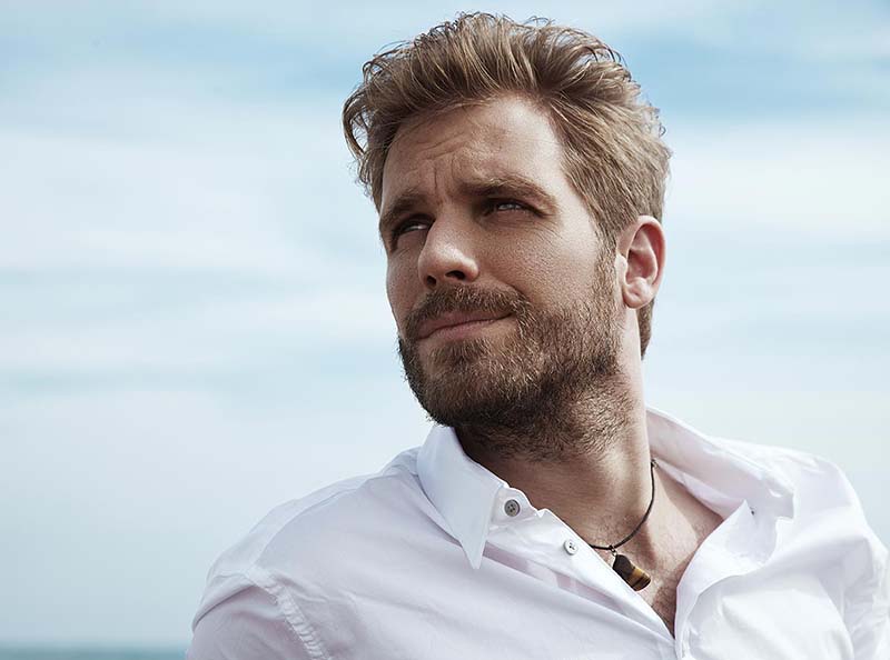 A handsome man shows off his great neck lift results.